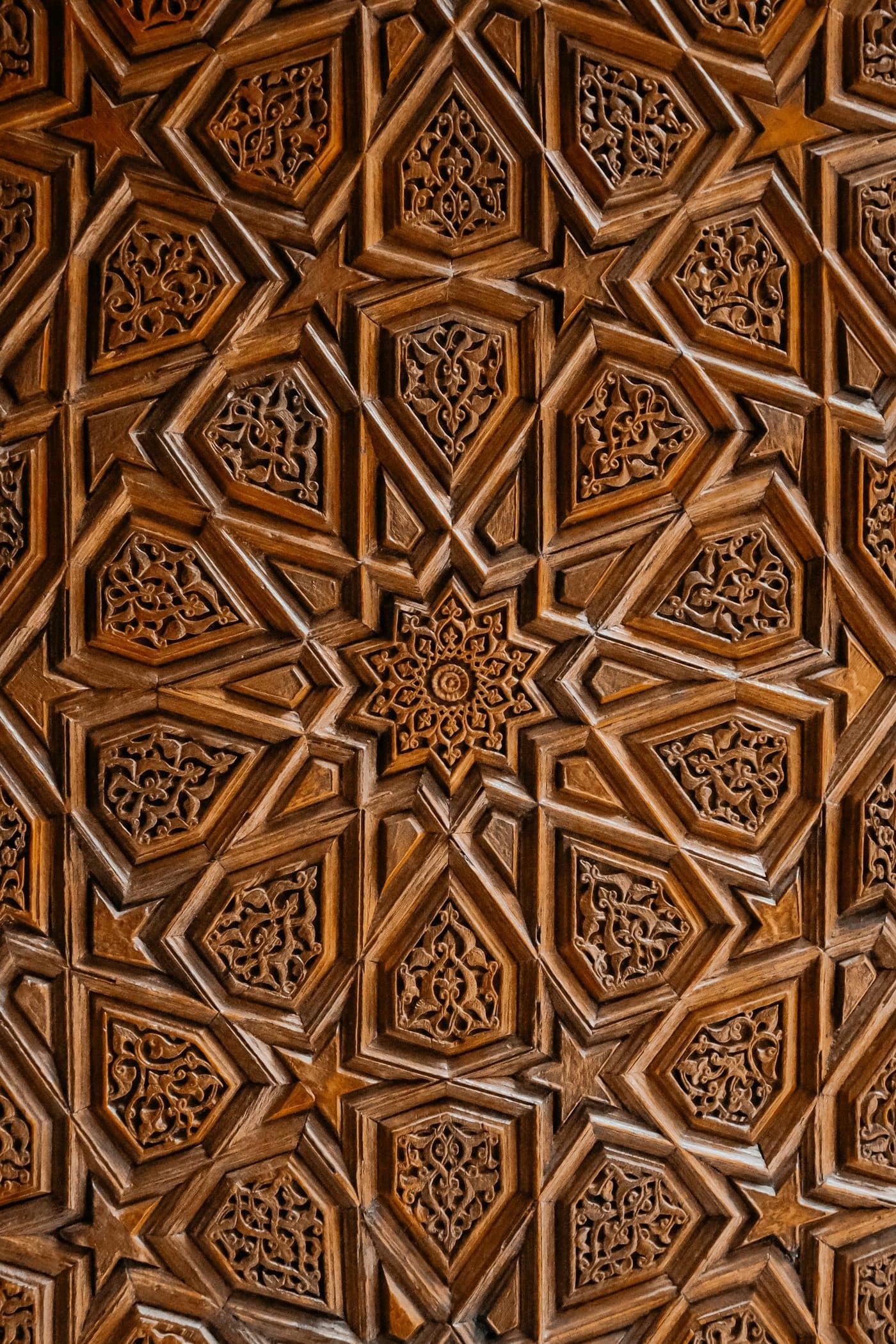 A carved wooden door panel centred on an eight-point star.