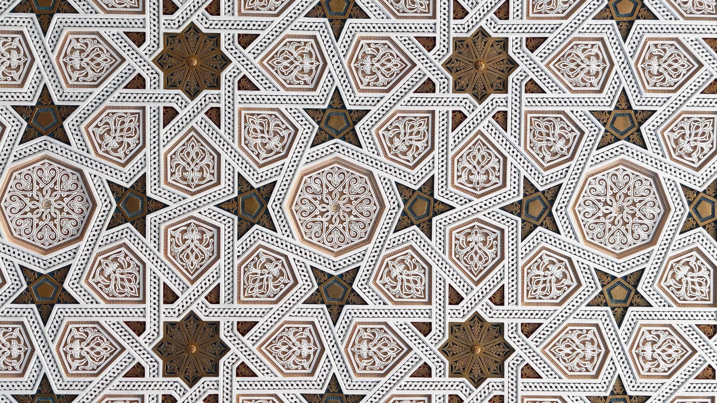 Carved plaster worked in interlocking star medallions.